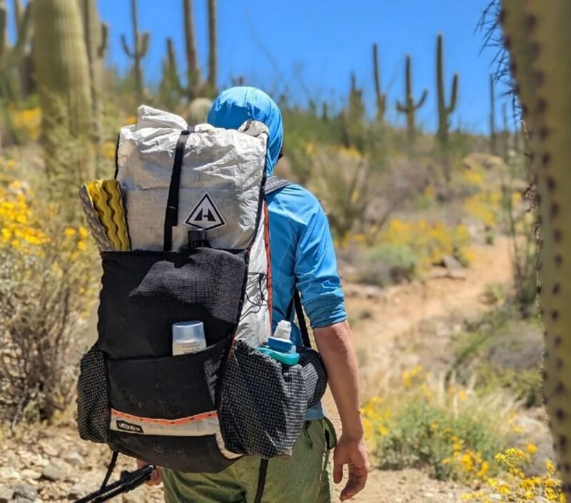 Backpacker walking through dessert. IBS-friendly travel tips