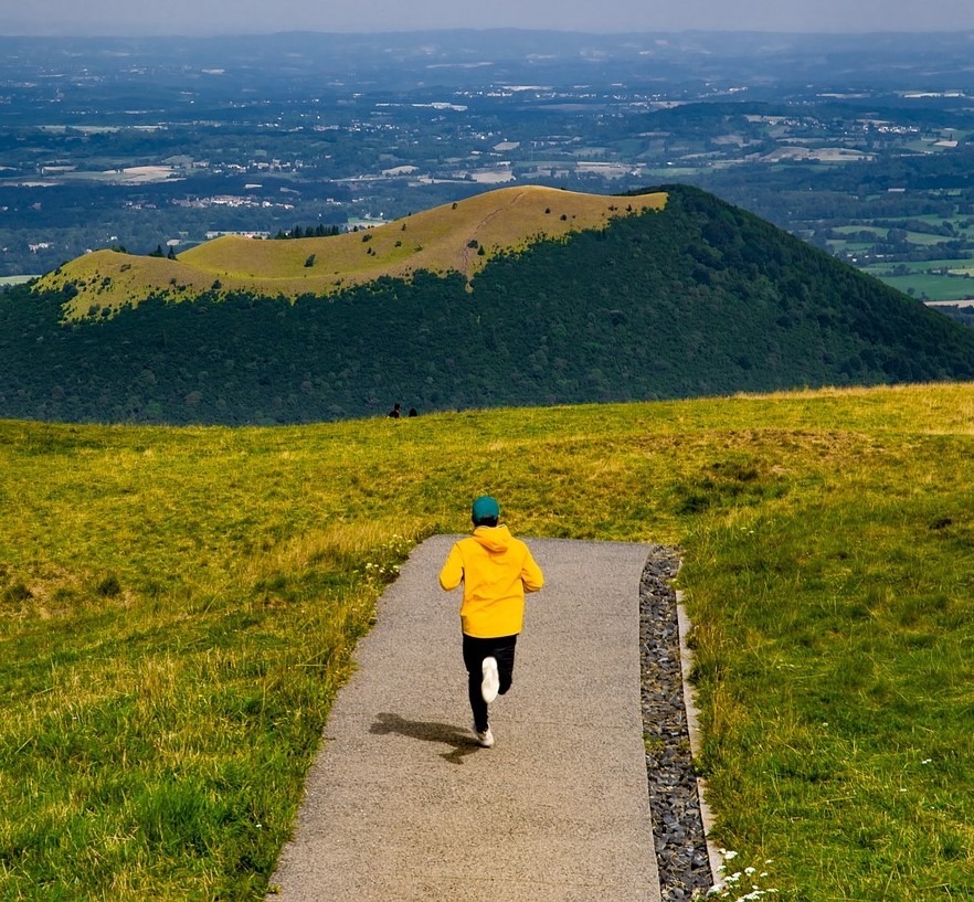 A picture showing a runner in the mountains - Exercise and IBS - finding the right balance