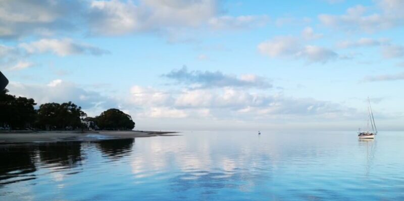 Picture of calm waters with boat. Taming the IBS gut, FODMAP Dietitian