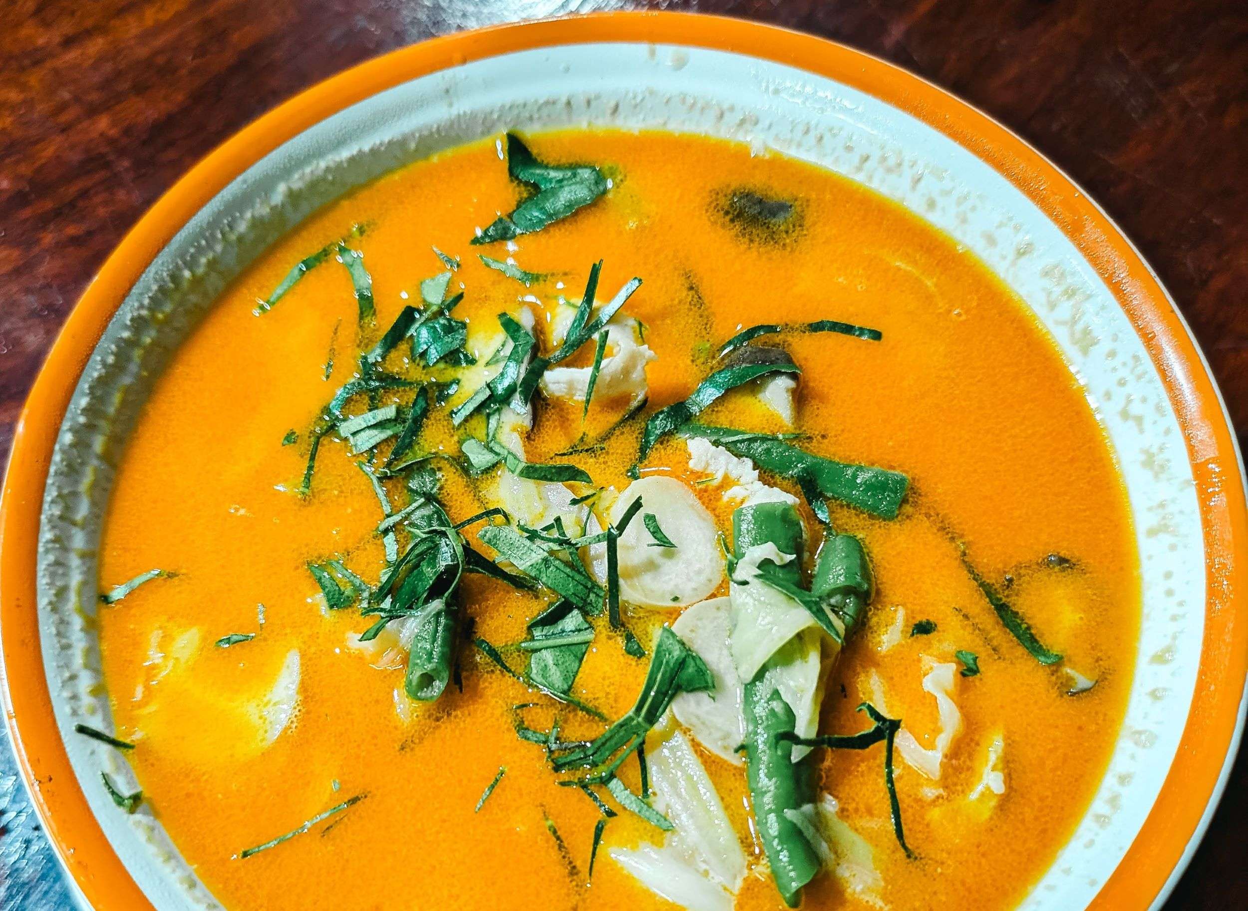 Dish showing poached cod in tomato broth, a low FODMAP dish