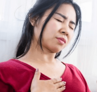 Woman displaying chest pain. Reflux and IBS