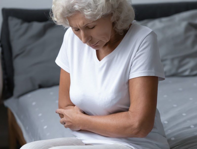 Picture showing older woman with gut pain