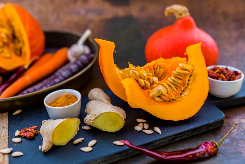 Chopping board showing ingredients to make a low FODMAP Roast Vegetable Curry
