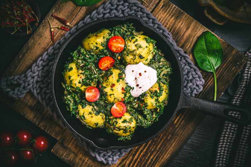 A pan showing a low FODMAP Saag Aloo