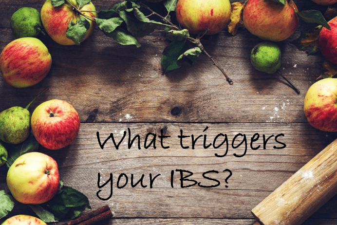 A wooden board surrounded by fruit with the words "What triggers your IBS?"