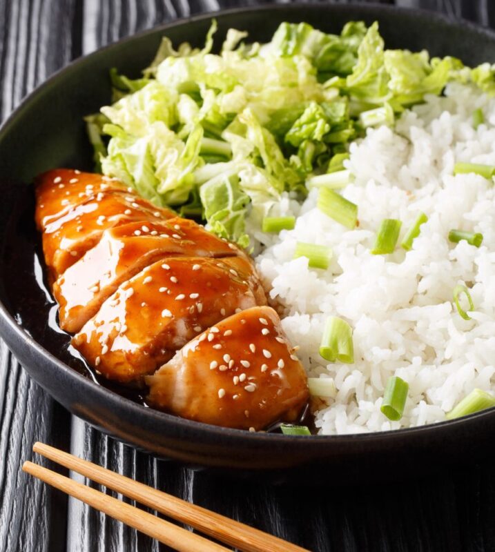 An image showing Teriyaki Salmon alongside boiled rice and cabbage