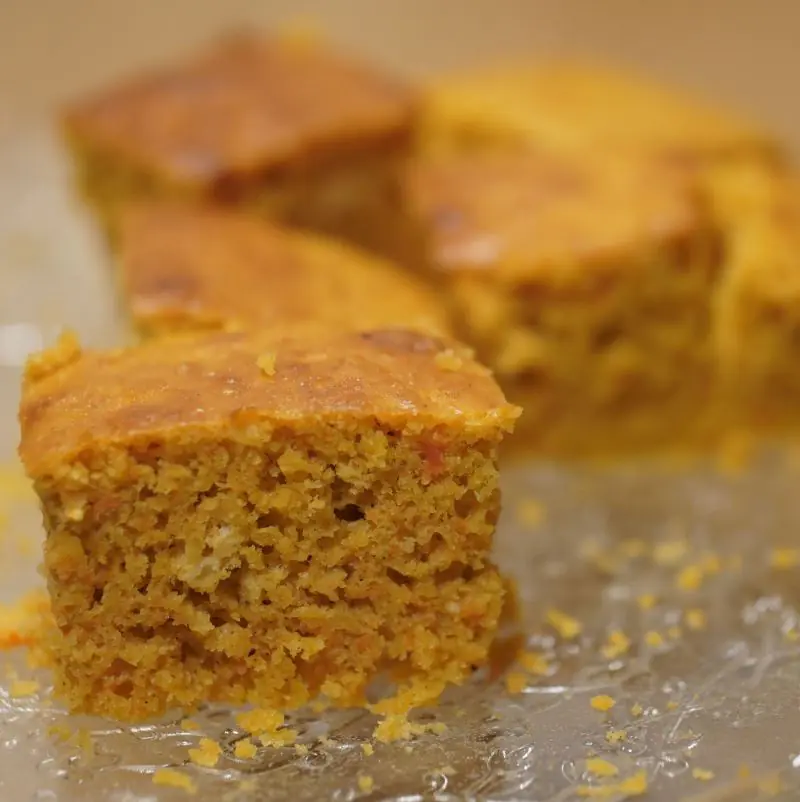 A close up image of a square of low FODMAP Pumpkin and Ginger Cake on a glass plate